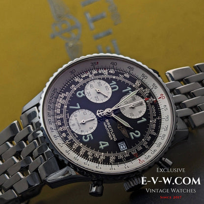 Close-up of a Breitling watch with a detailed face on a dark background, featuring the brand name 'E-V-W.COM'.