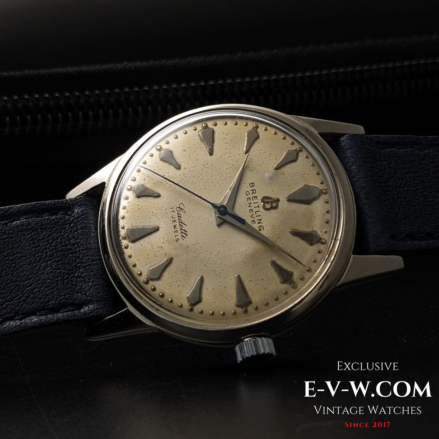 Side view of Vintage Breitling Geneve Cadette Watch 1960s highlighting domed crystal and silver-tone case with blue leather strap.