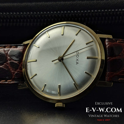 Side profile of DOXA Vintage 14k Gold Watch 1950 with domed crystal and gold crown, emphasizing its slim and elegant construction.