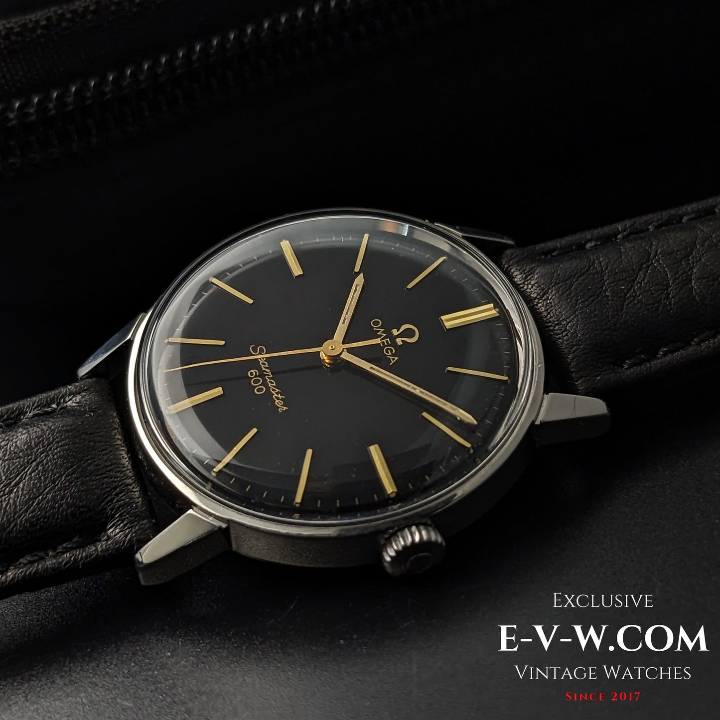 Omega Seamaster 600 1966 Ref. 135011 displayed at an angle, showing black dial, gold hands, and vintage case design on leather strap.