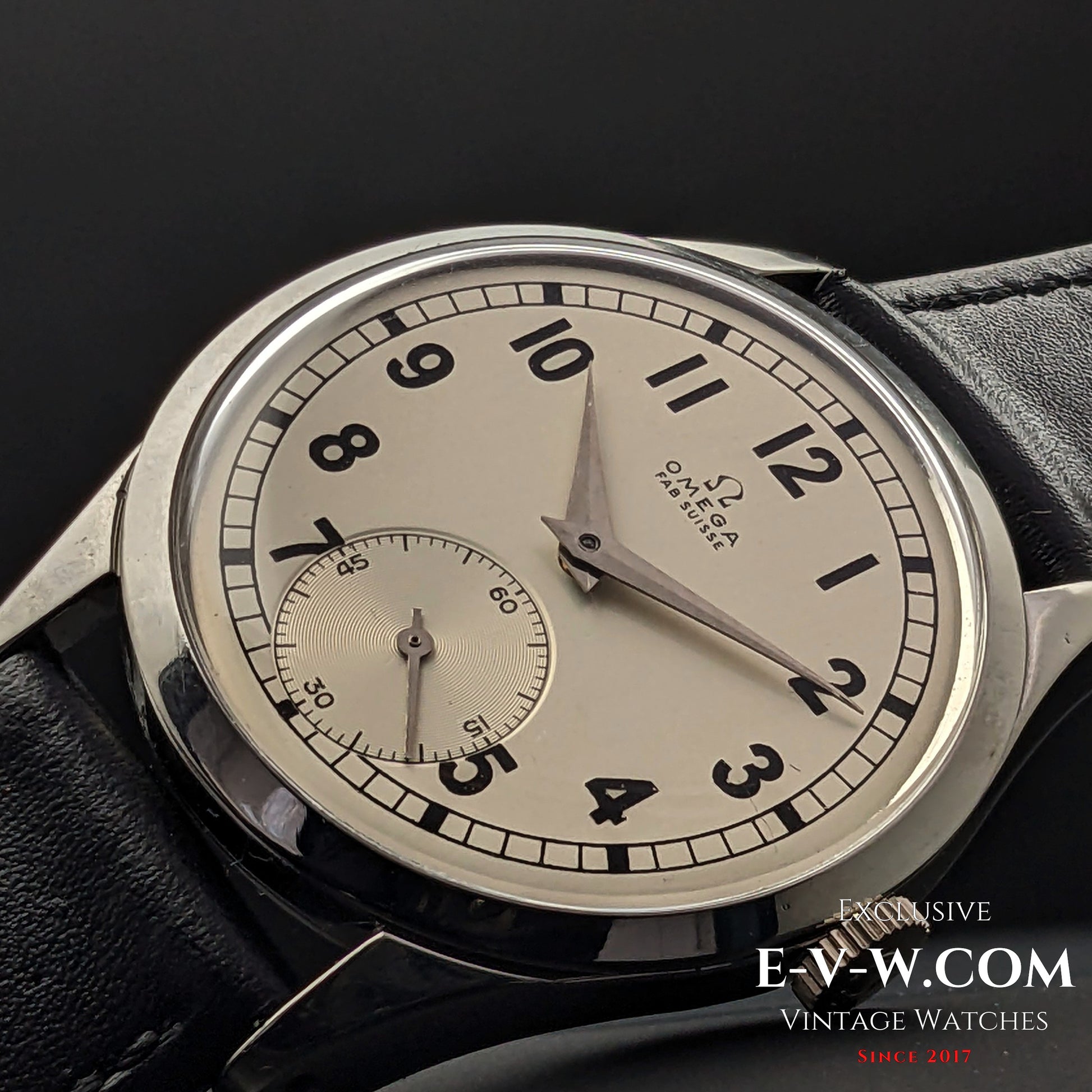 Macro shot of the Omega FAB SUISSE Ref. 2750-6 vintage wristwatch, showcasing its detailed silver dial, black numerals, and subdial.