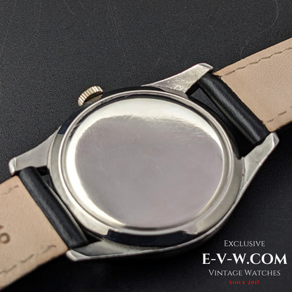 Back view of the Omega FAB SUISSE Ref. 2750-6 vintage wristwatch, featuring a polished stainless steel case and black leather strap.