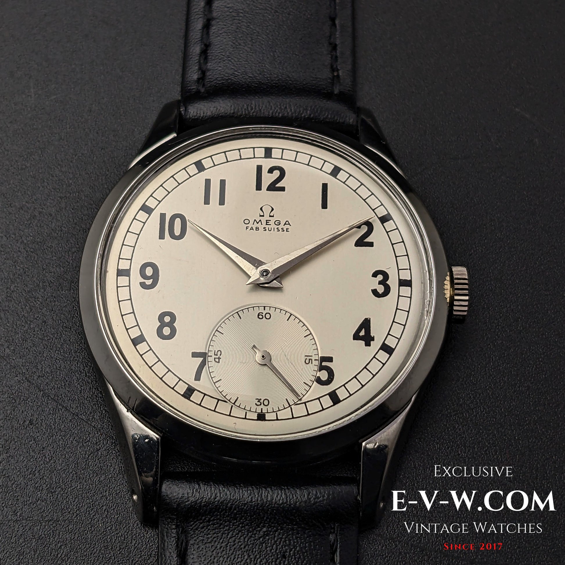 Front view of the Omega FAB SUISSE Ref. 2750-6 vintage wristwatch, showcasing its silver dial, black numerals, and subdial at 6 o’clock.