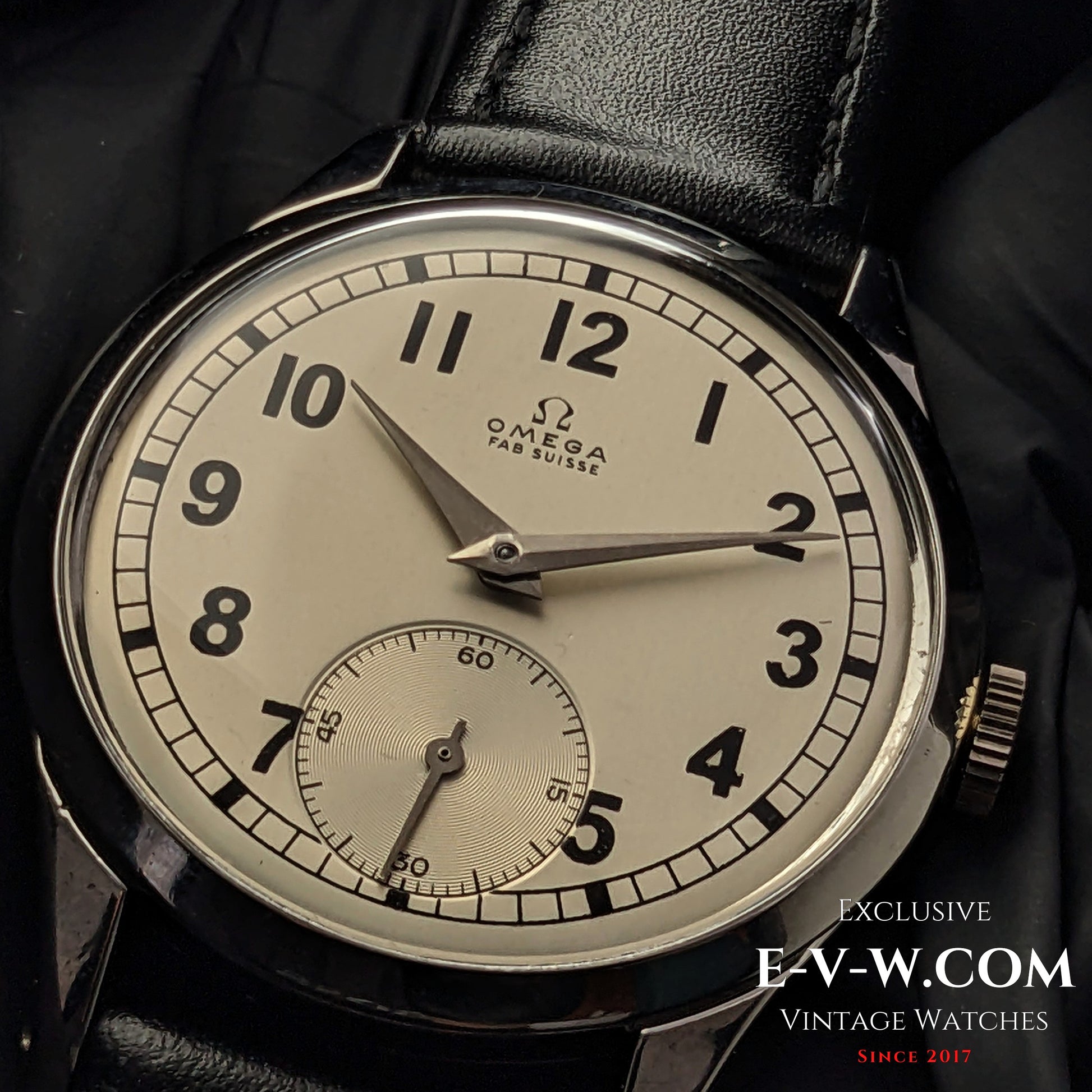 Vintage Omega FAB SUISSE Ref. 2750-6 wristwatch with a silver dial, black numerals, and a subdial at 6 o’clock. Classic 1954 timepiece with a black leather strap.