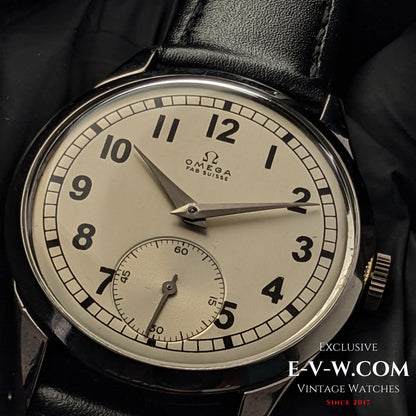 Vintage Omega FAB SUISSE Ref. 2750-6 wristwatch with a silver dial, black numerals, and a subdial at 6 o’clock. Classic 1954 timepiece with a black leather strap.