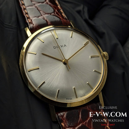 Buy DOXA Vintage 14k Gold Watch 1950 with silver sunburst dial, minimalist gold indices, and brown leather strap, perfect for collectors of classic timepieces.