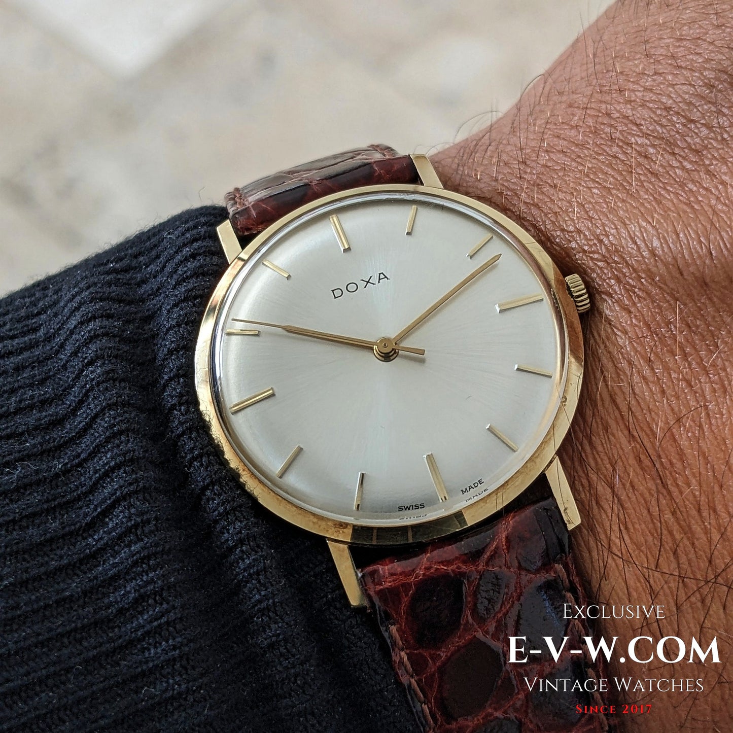 Elegant 75-year-old DOXA 14k gold vintage watch worn on wrist, showcasing timeless Swiss design and refined craftsmanship from the 1950s.