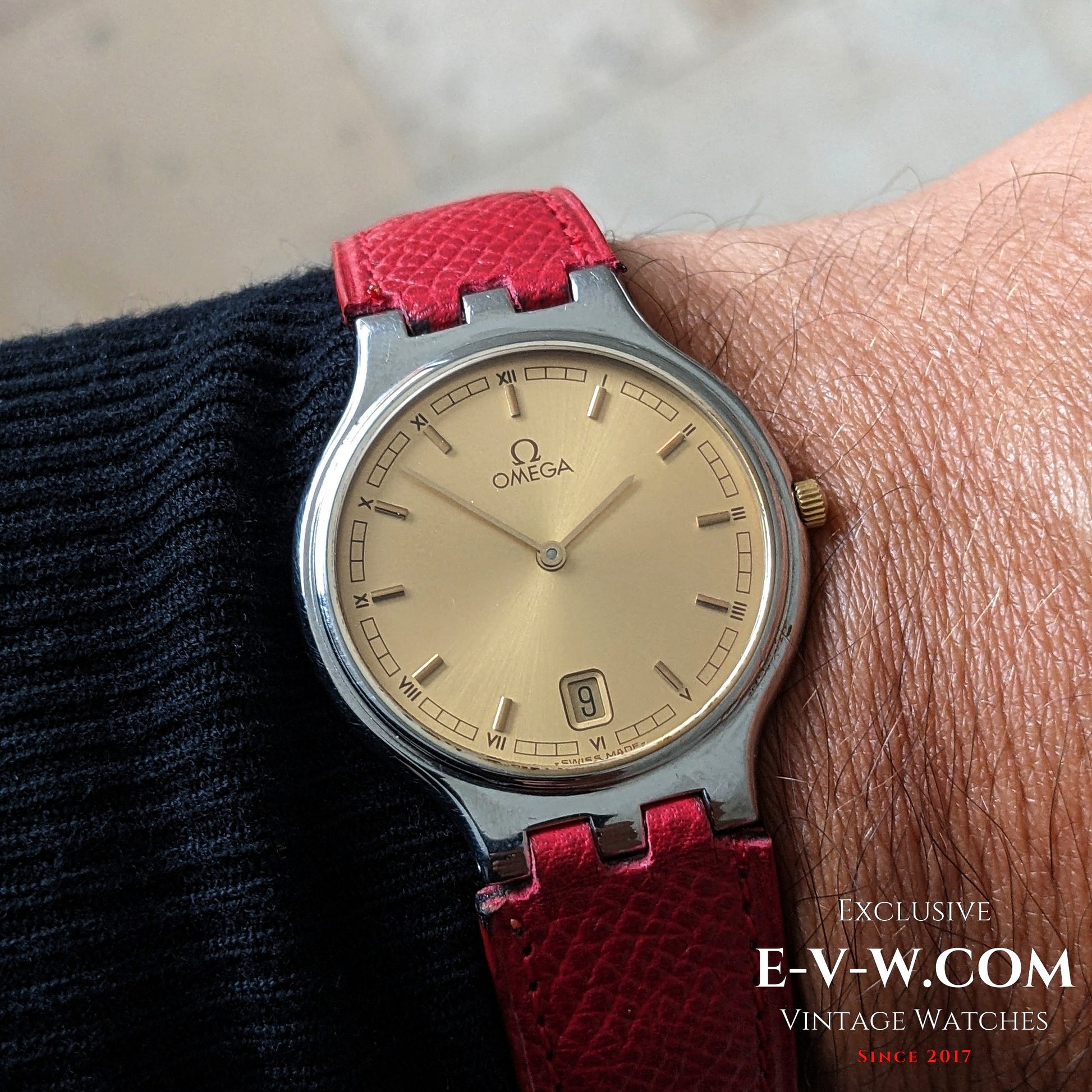 Omega vintage 24-hour dial wristwatch worn on wrist, featuring gold dial and red strap, Ref. 3961016 Cal. 1436, classic men's timepiece.
