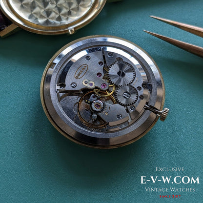 Detailed view of the DOXA Caliber 103 manual movement inside the 1950 vintage 14k gold watch, highlighting Swiss mechanical precision.