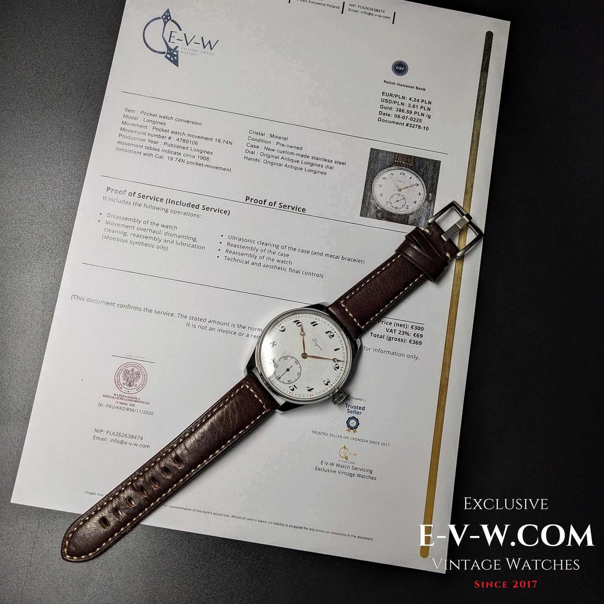 Vintage watch with brown strap on a document, featuring E-V-W branding.