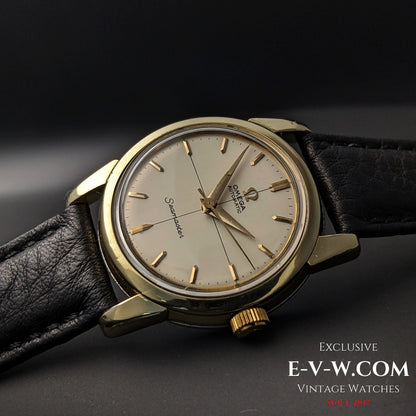 Angled view of Omega Seamaster 2828-9SC Cal. 471 vintage watch with gold-tone bezel and cream dial on black leather strap.