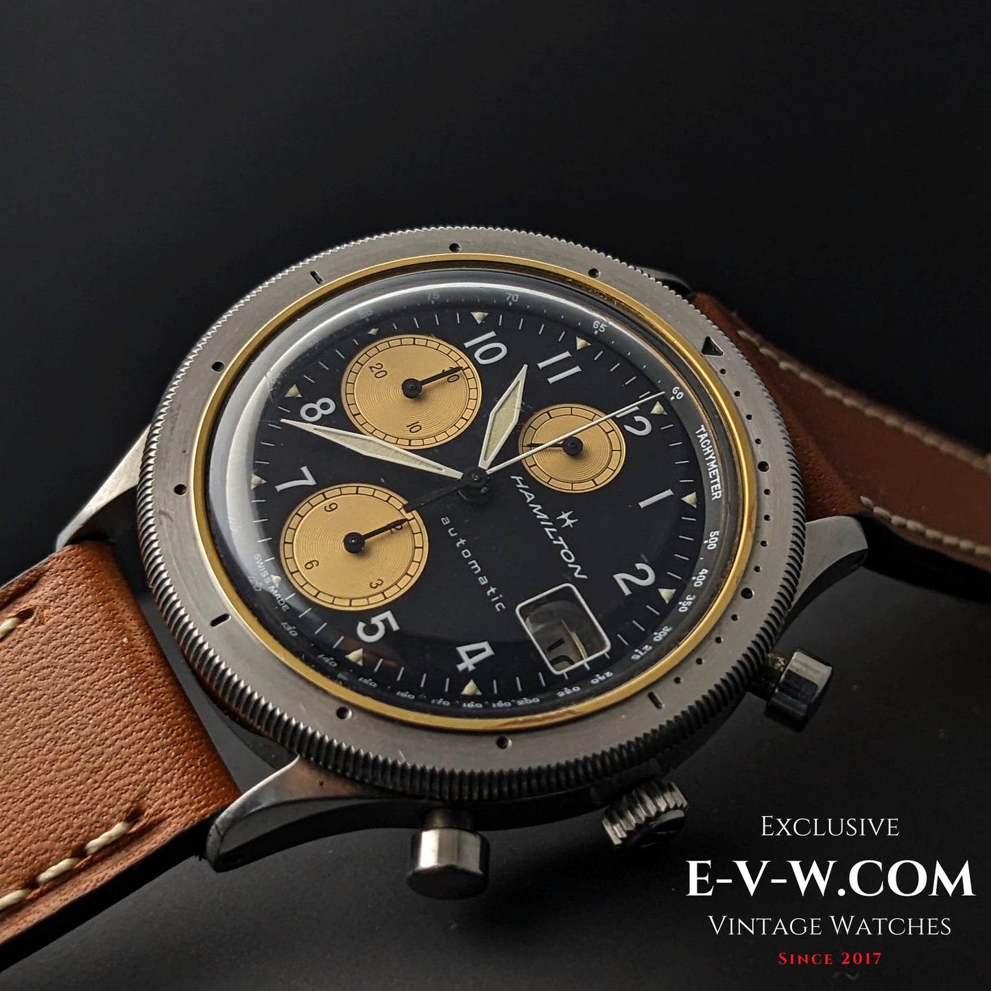 Angled view of Vintage Hamilton Automatic Chronograph for Collectors with black dial, gold subdials, and brown leather strap.