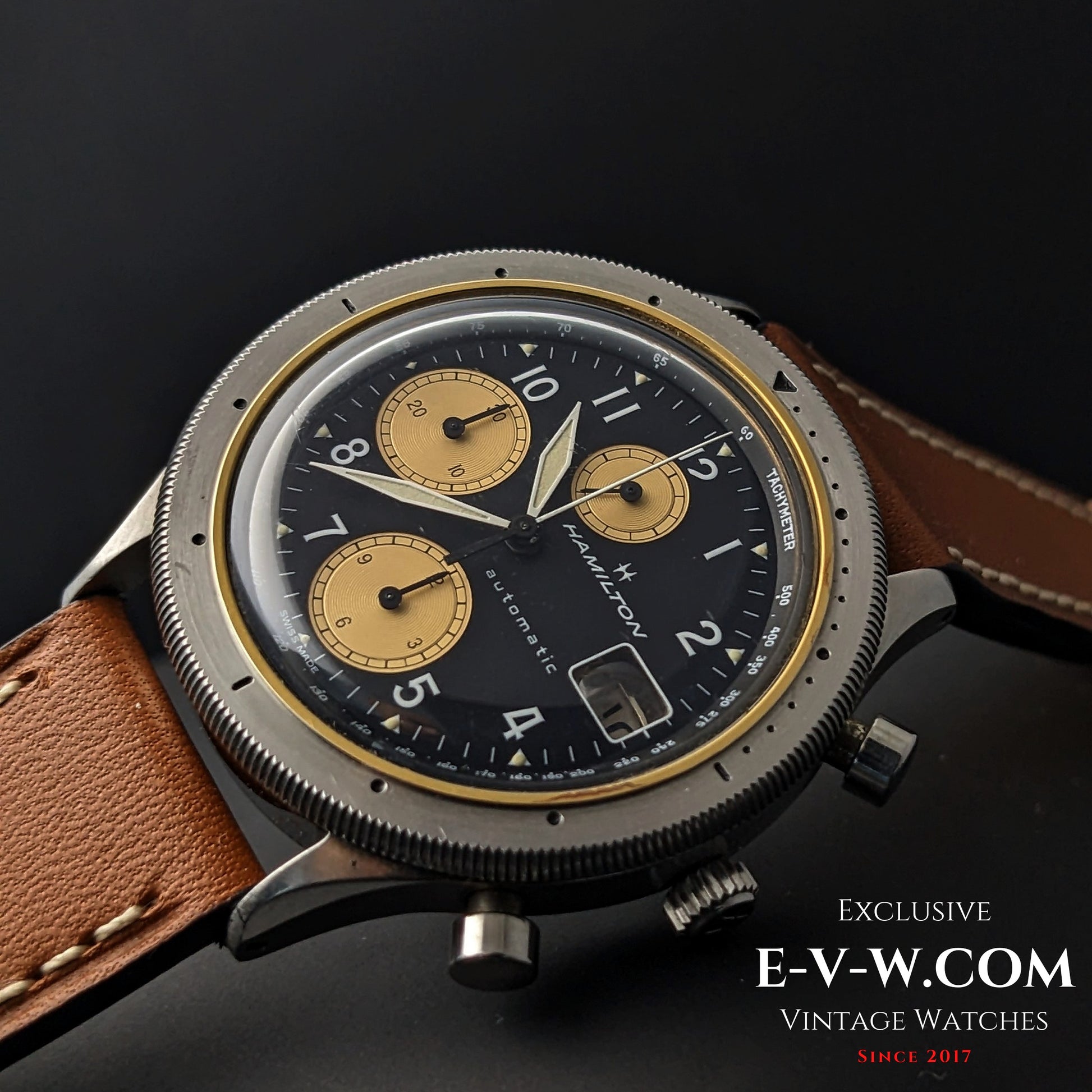 Angled view of Vintage Hamilton Automatic Chronograph for Collectors with black dial, gold subdials, and brown leather strap.