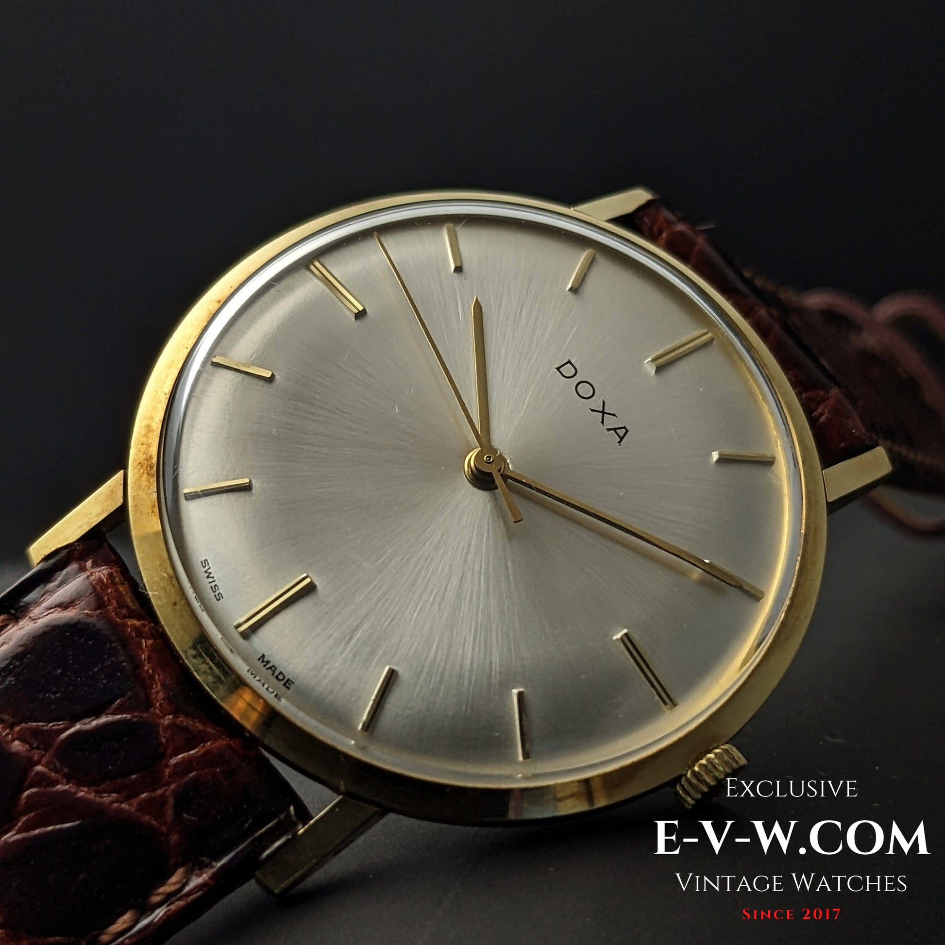 Angled view of DOXA Vintage 14k Gold Watch 1950 with sunburst silver dial and gold hands, ideal for vintage watch collectors and enthusiasts.