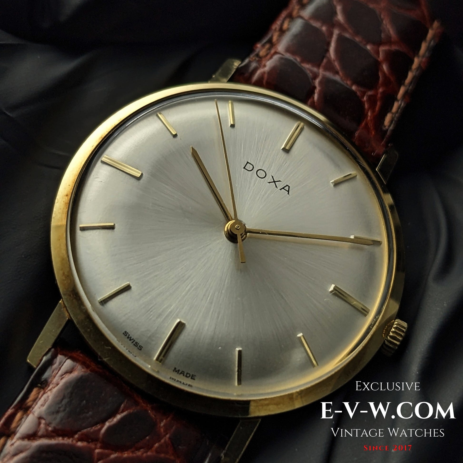 Macro shot of DOXA Vintage 14k Gold Watch 1950 highlighting the refined gold case, silver dial, and Swiss craftsmanship details.