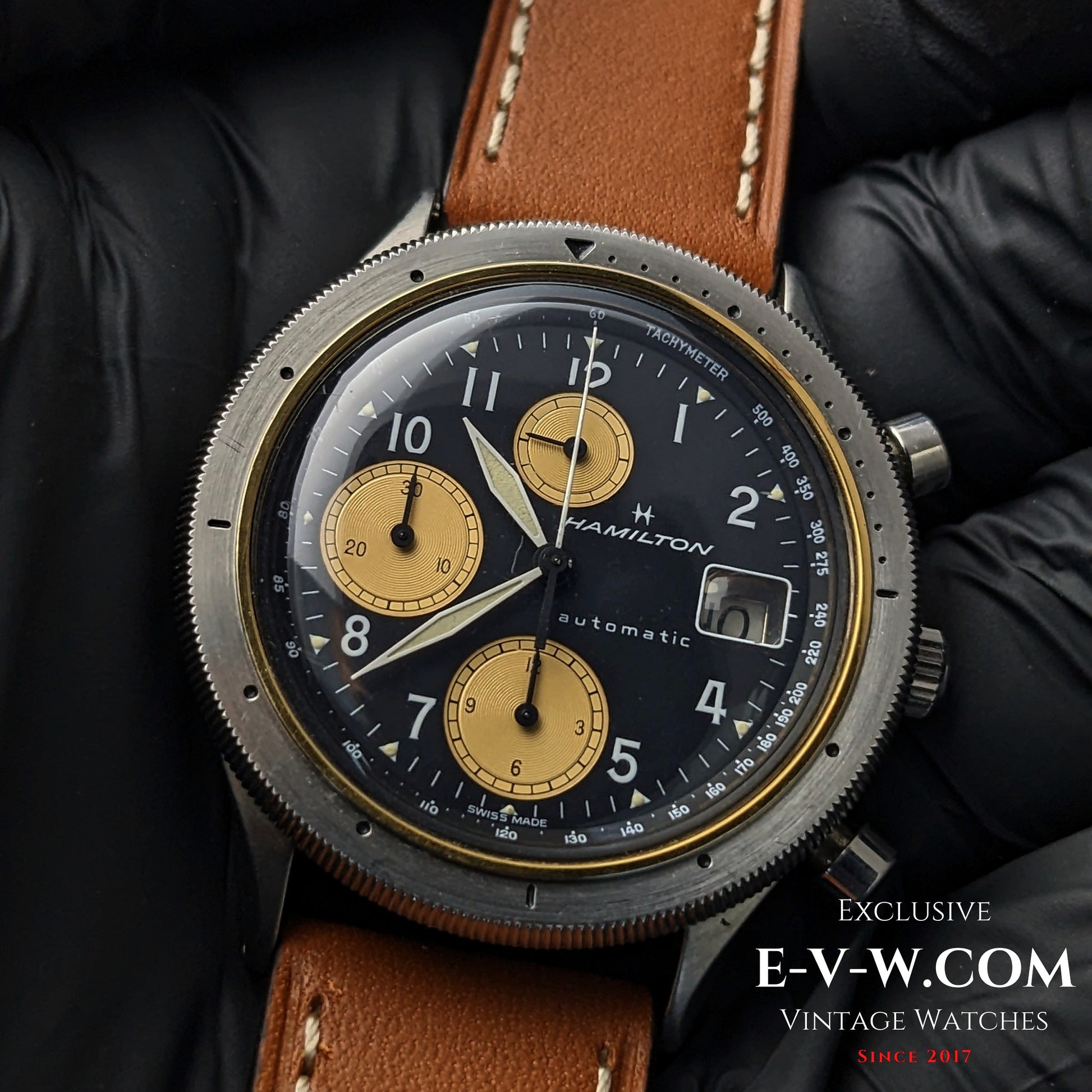 Vintage Hamilton Automatic Chronograph for Collectors featuring a black dial with gold subdials, Cal. LWO 283 movement, and brown leather strap.