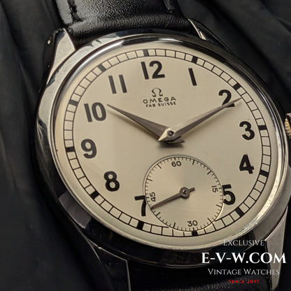 Detailed view of the Omega FAB SUISSE Ref. 2750-6 vintage wristwatch, highlighting its silver dial, black numerals, and subdial at 6 o’clock.