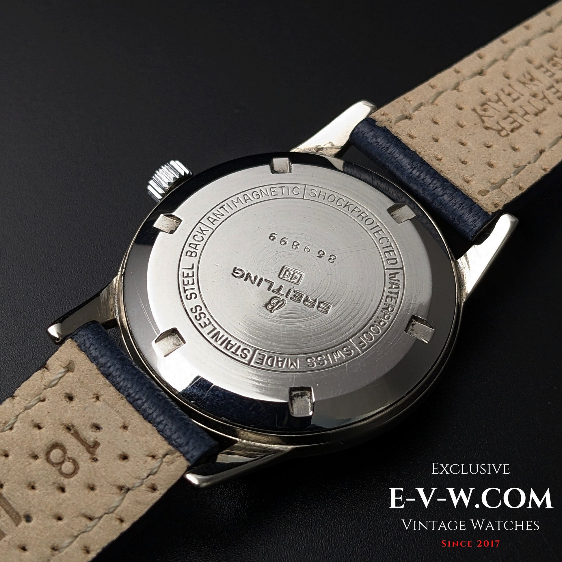 Rear view of Vintage Breitling Geneve Cadette Watch 1960s showing stainless steel back with engraved model number and leather strap.