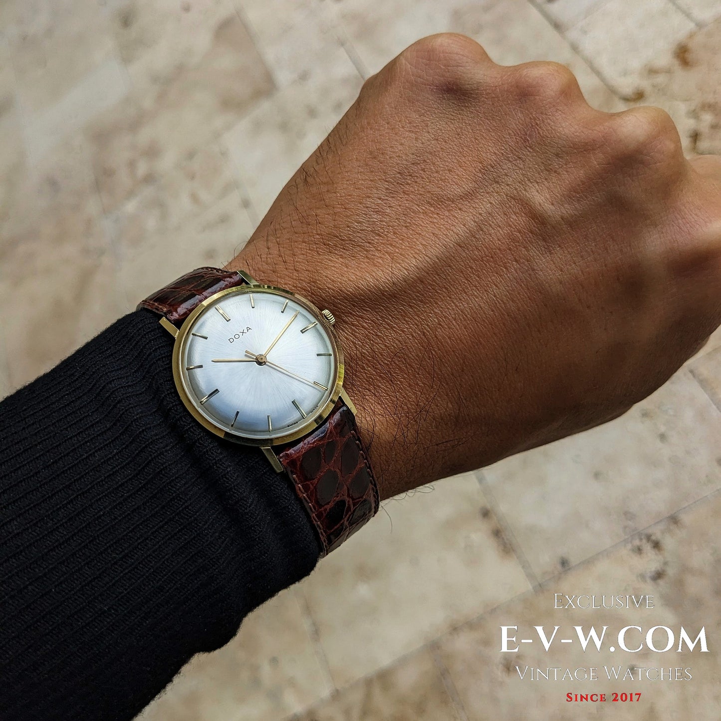 DOXA 14k gold vintage watch from 1950 worn on wrist, showcasing slim profile and elegant design suitable for formal and classic attire.