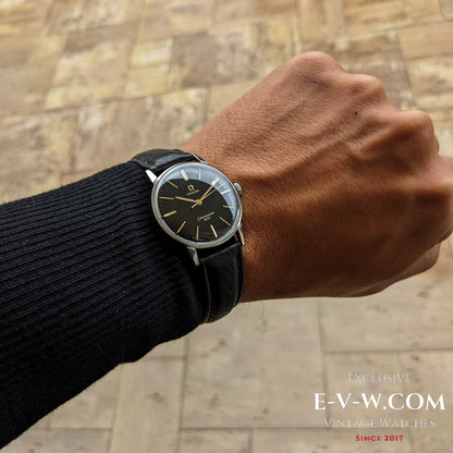 Omega Seamaster 600 1966 Ref. 135011 worn on wrist, showcasing its classic black and gold dial with vintage appeal and leather strap.