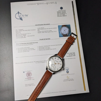 Watch with brown leather strap on a document with text and logos