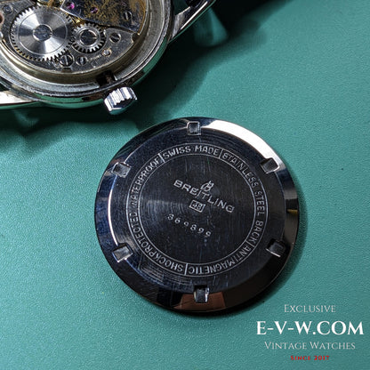 Back case of Vintage Breitling Geneve Cadette Watch 1960s engraved with branding and specifications like antimagnetic and shockproof features.