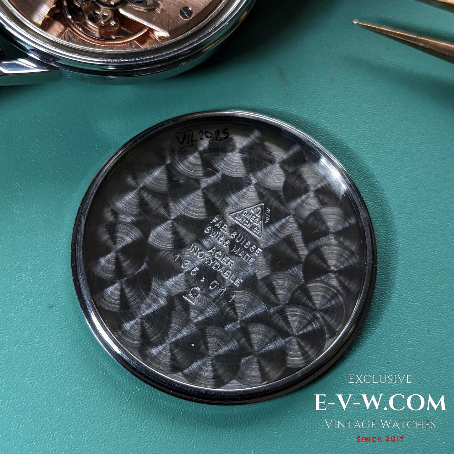 Inside case back of Vintage Omega Seamaster 600 1966 Ref. 135011 showing Swiss hallmark, reference number, and brushed metal finish.