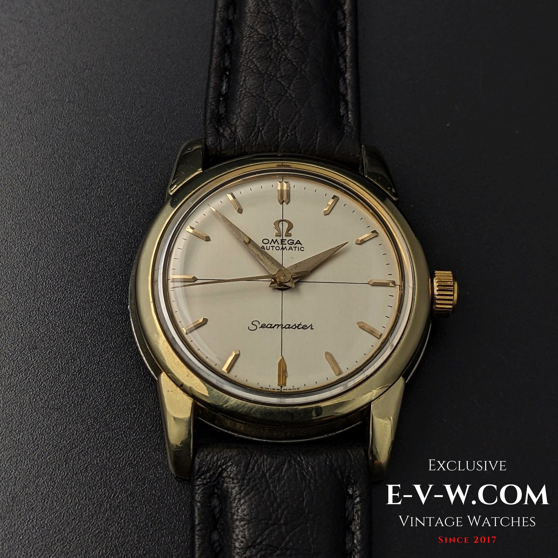 Centered view of 1958 Omega Seamaster Ref. 2828-9SC Cal. 471 with gold-tone case, cream dial, and black leather strap.