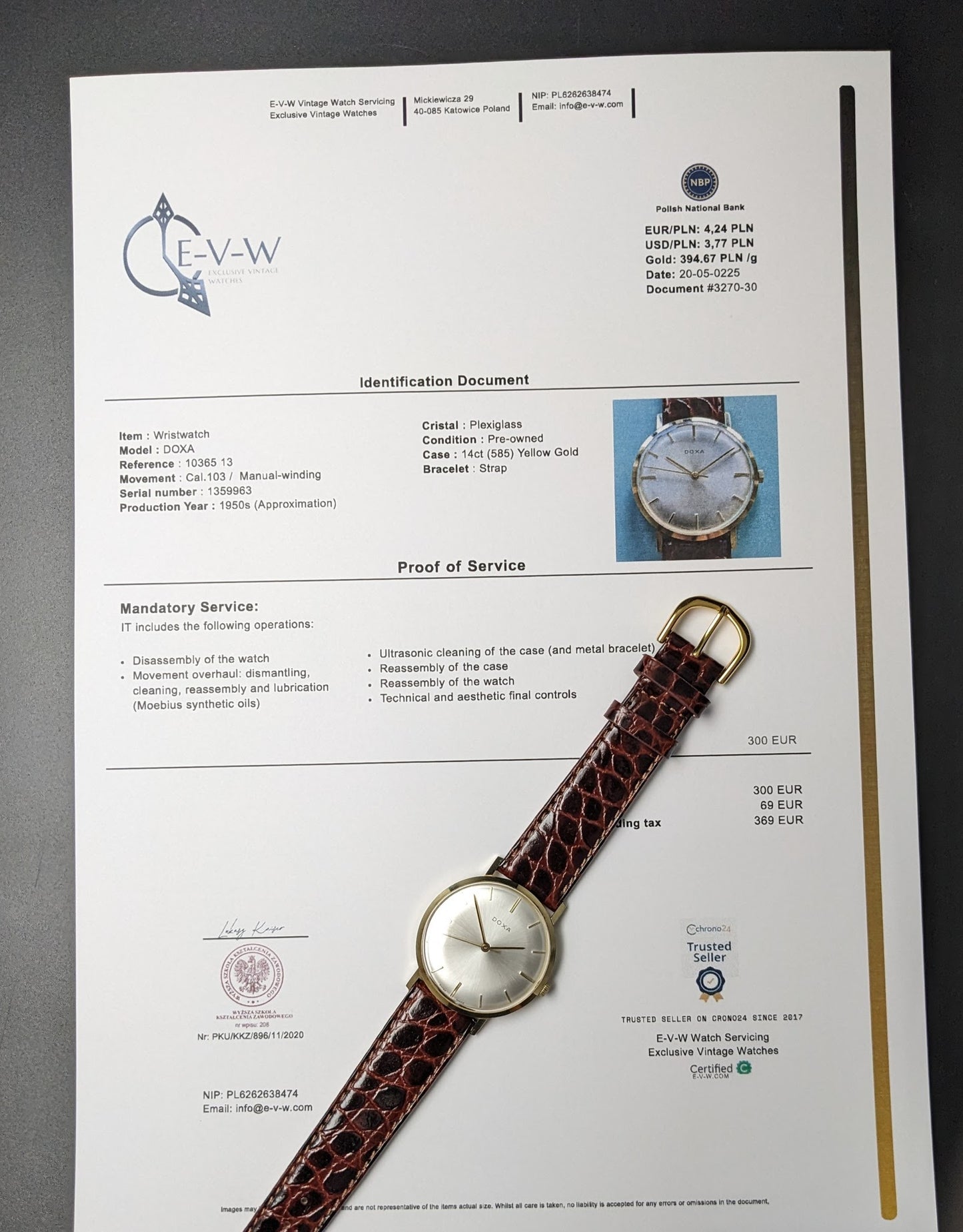 DOXA Vintage 14k Gold Watch 1950 displayed with official service documentation, confirming authenticity and recent maintenance of Caliber 103 movement.