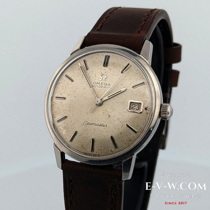 Vintage Omega Seamaster watch with brown leather strap on a light gray background